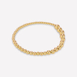 A gold-colored bracelet featuring a series of round beads along its length.