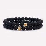 Matte onyx beaded bracelet with single yellow gold bead stack for men