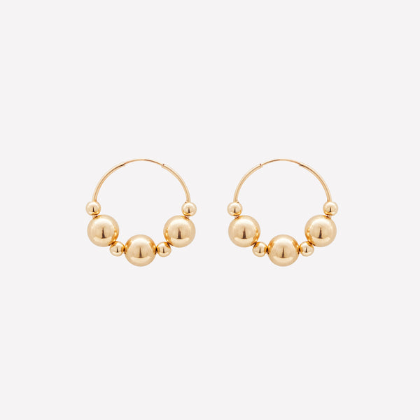 Yellow gold medium hoop earrings with gold beads for women