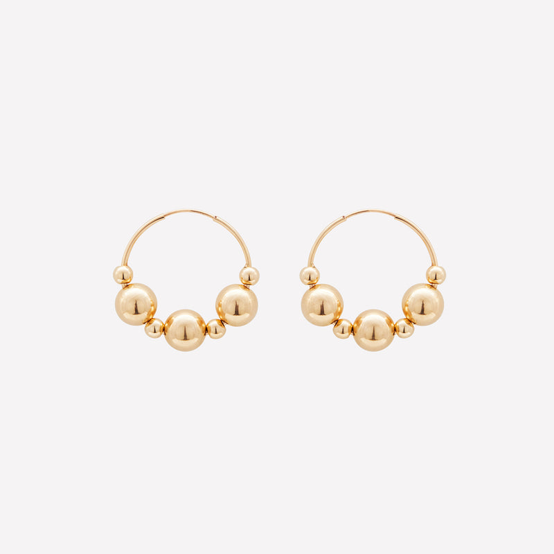 Yellow gold medium hoop earrings with gold beads for women