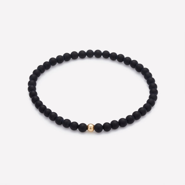 Matte onyx beaded bracelet with single yellow gold bead for men
