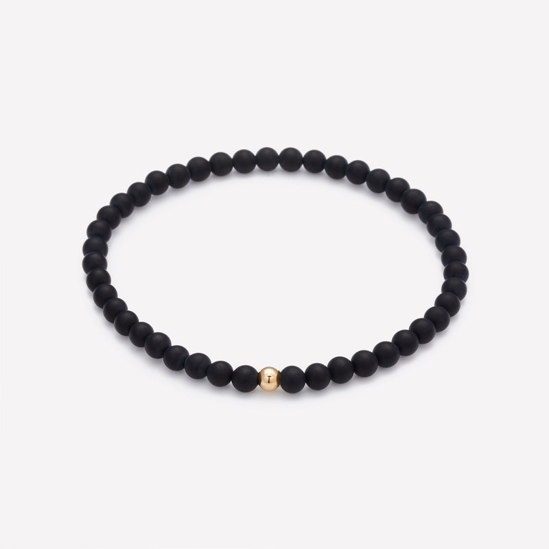 Matte onyx beaded bracelet with single yellow gold bead for men