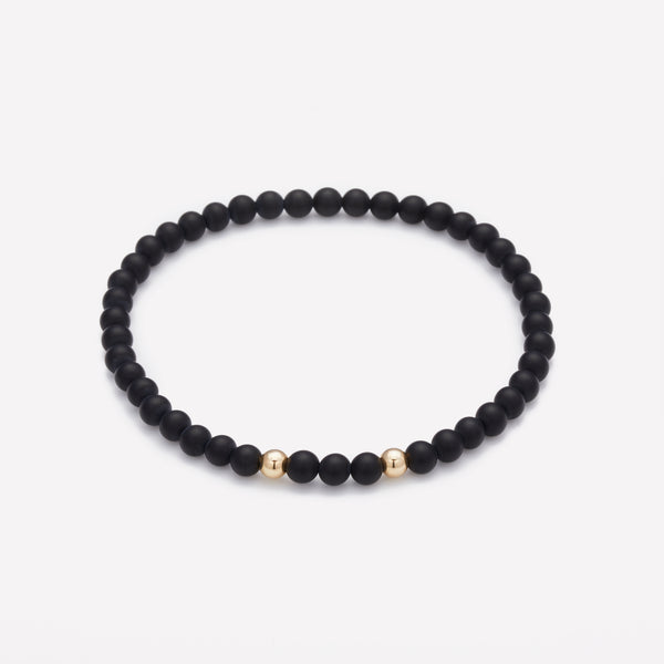 Matte onyx beaded bracelet with double yellow gold beads for men