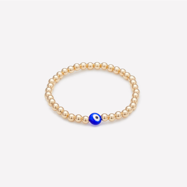 Yellow gold beaded bracelet with blue glass evil eye as seen in vanity fair for kids