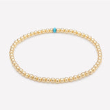 Yellow gold beaded anklet with single turquoise crystal for women