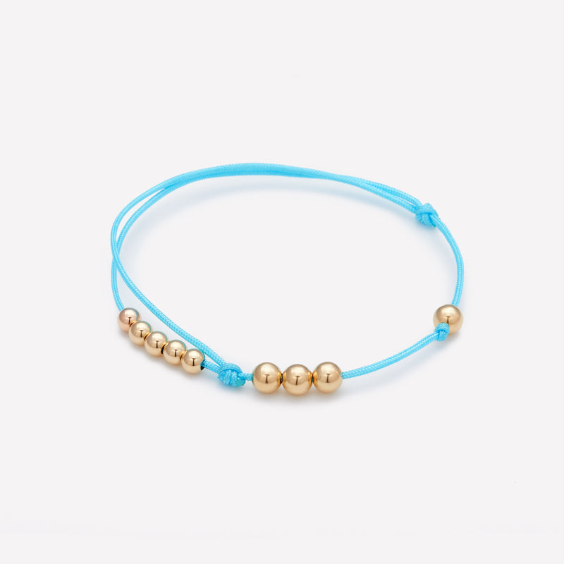 Turquoise silk string bracelet with yellow gold beads for men and women