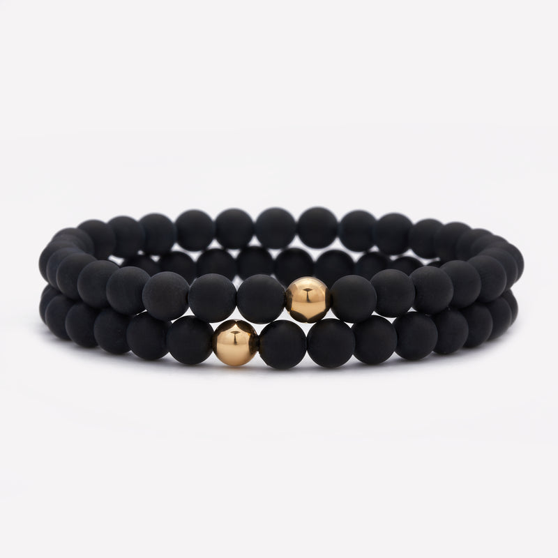 Matte onyx beaded bracelet with single yellow gold bead stack for men