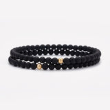 Matte onyx beaded bracelet with single yellow gold bead stack for men